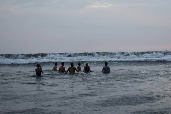 Group of people swimming in the ocean.