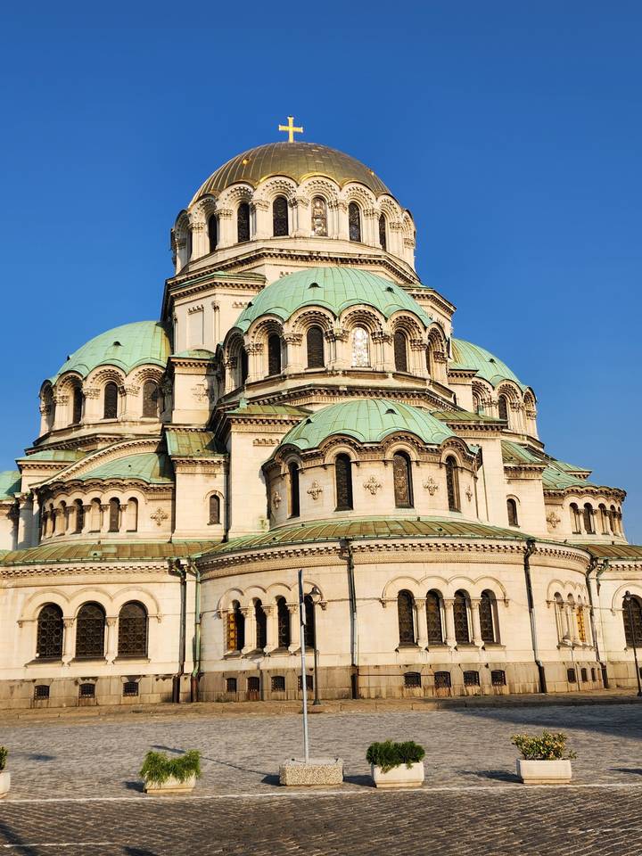 Large domed cathedral with greenery nearby.