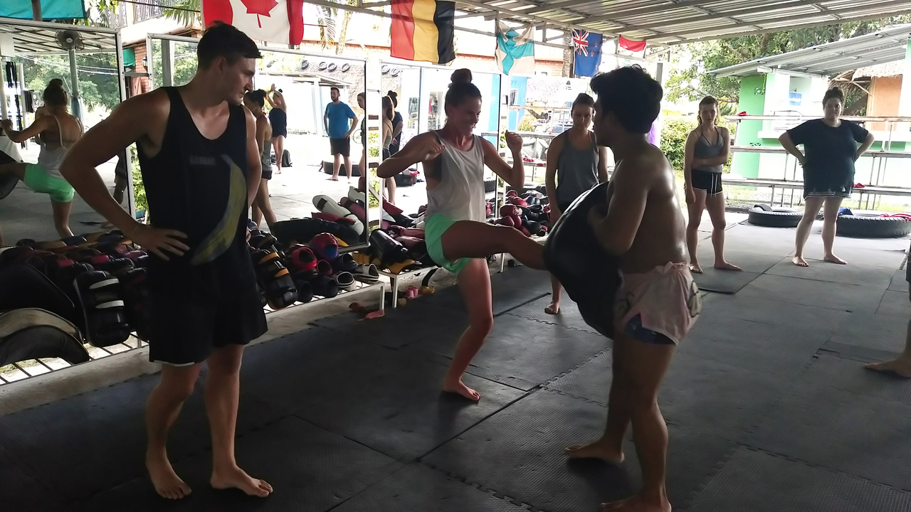 People practicing martial arts inside a gym.