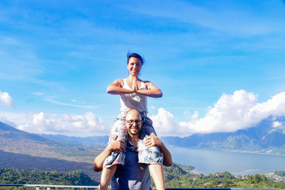 Man giving a piggyback ride with scenic mountain view.