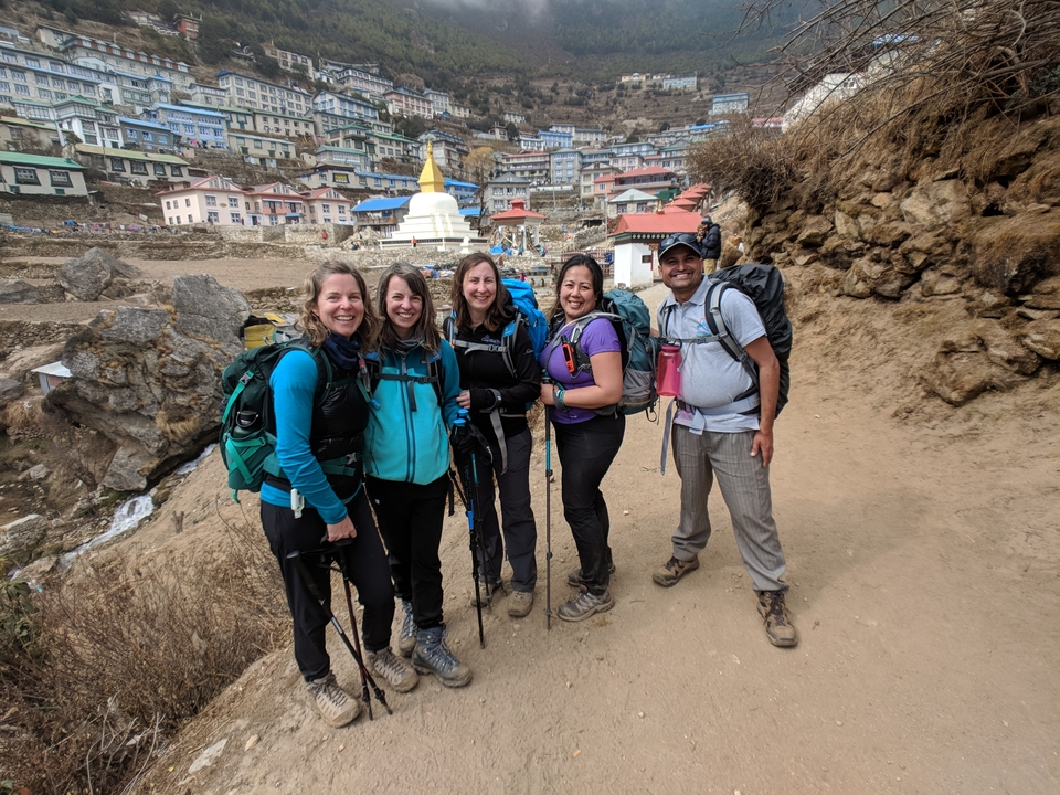 Group of trekkers with a stupa in the background.