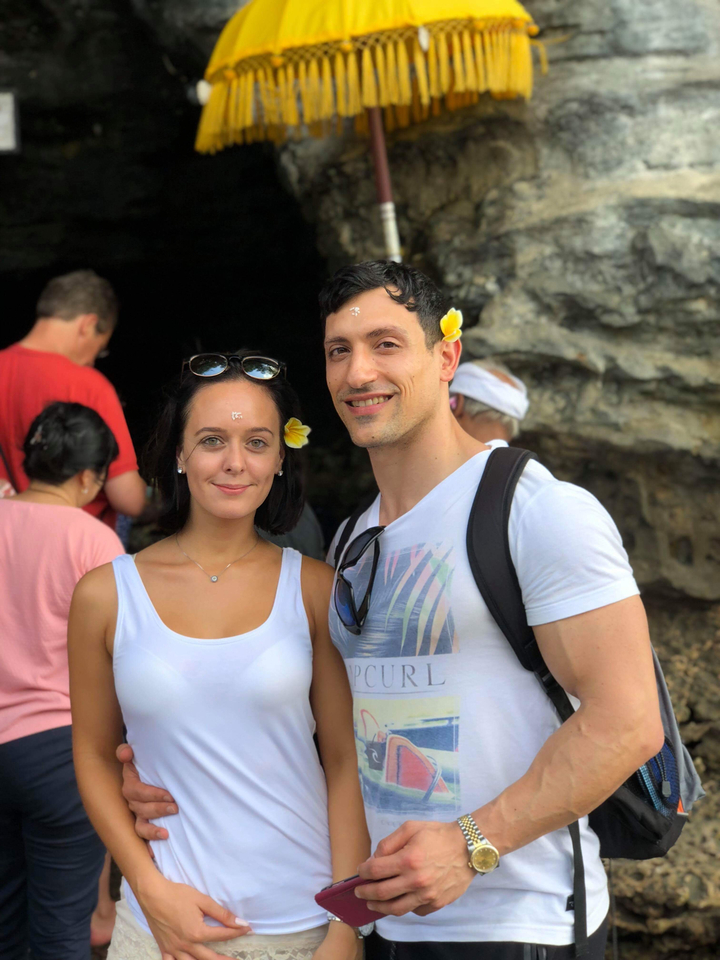 Couple posing with flowers in their hair.
