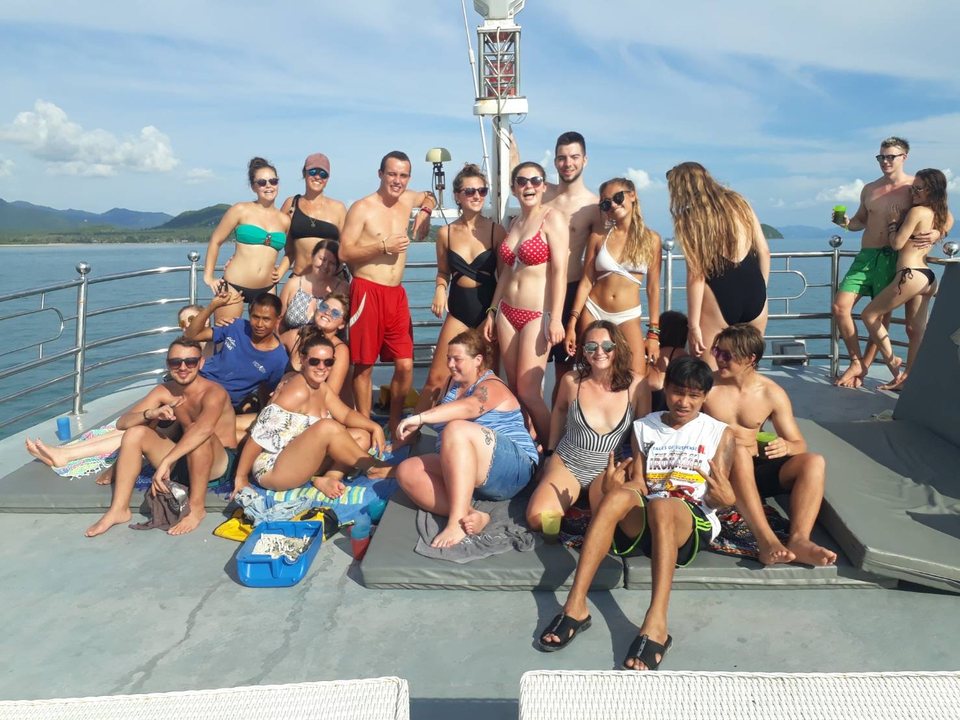 Large group posing on the deck of a boat.