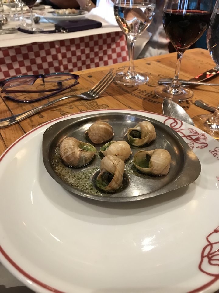Dishes of escargot served on a table at a restaurant.