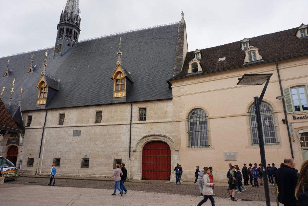 Bâtiment bourguignon avec des touristes à l'extérieur, capturant l'architecture historique.