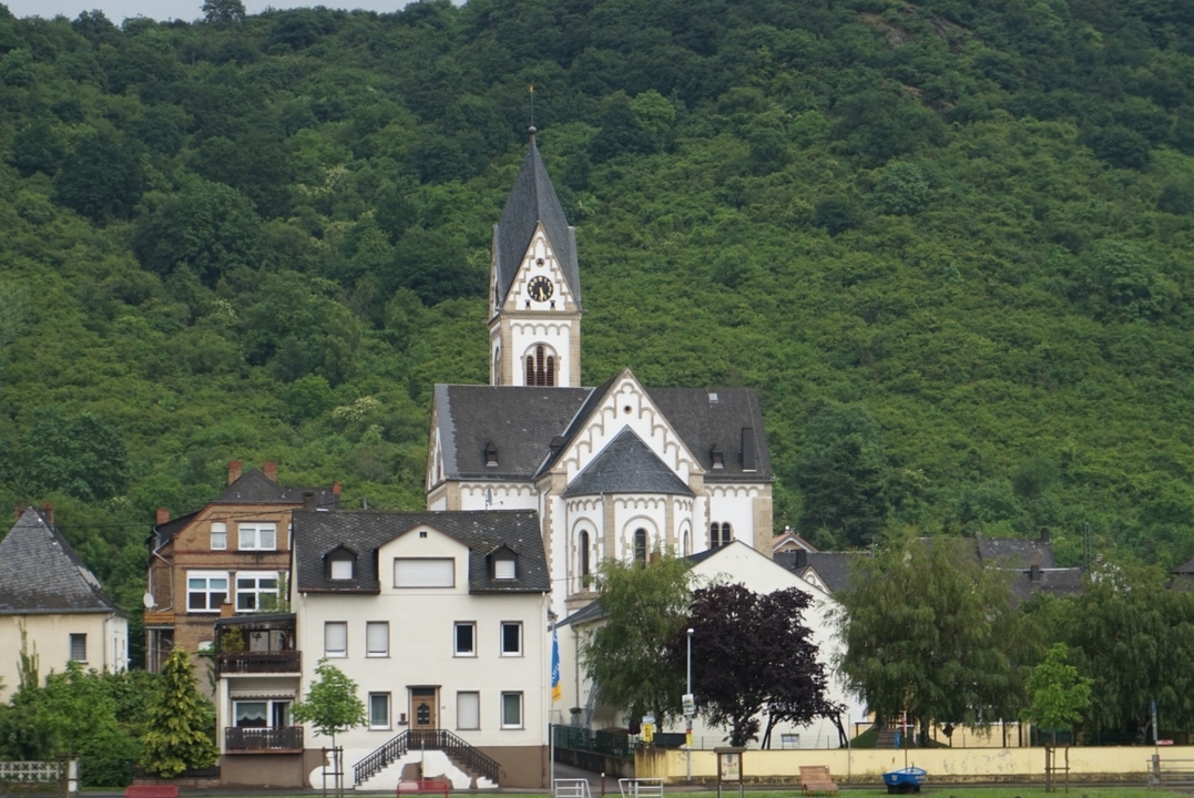 Small church with pointed roof in a rural town.