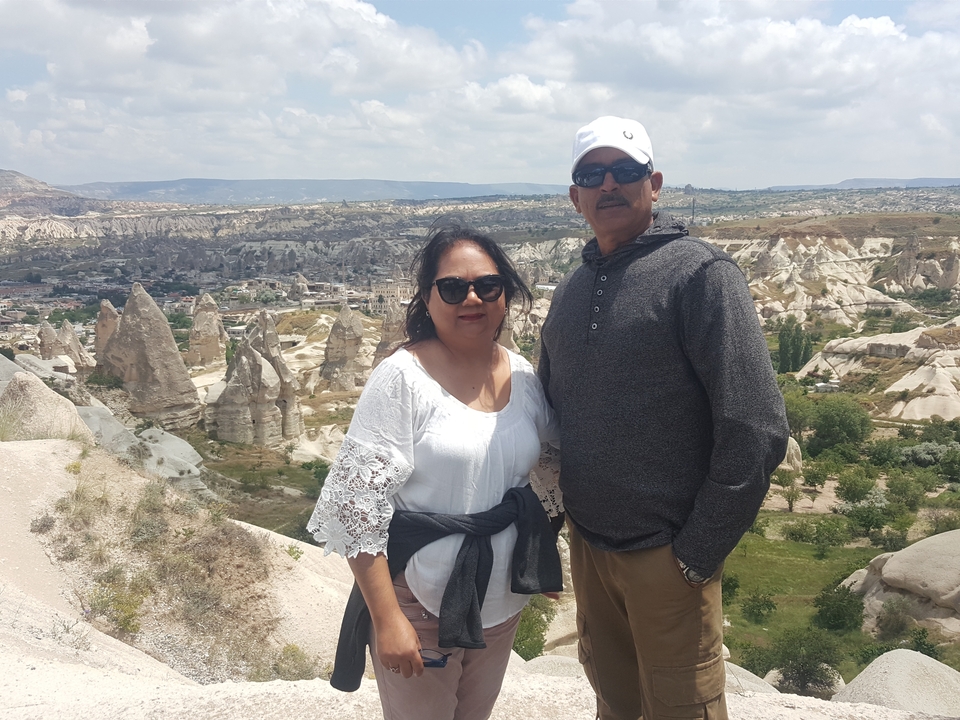 Couple posing with the unique rock formations in the background.
