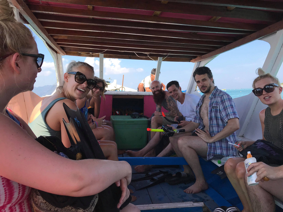 A group of people enjoying a boat ride on the sea.
