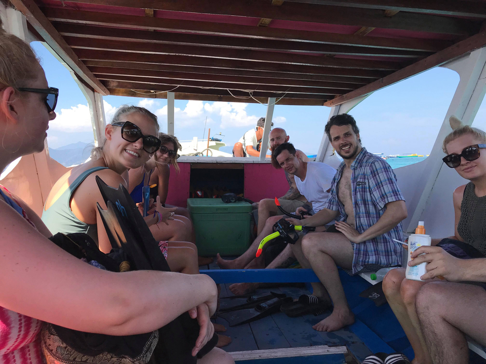 A group of people sitting inside a boat enjoying the ride.