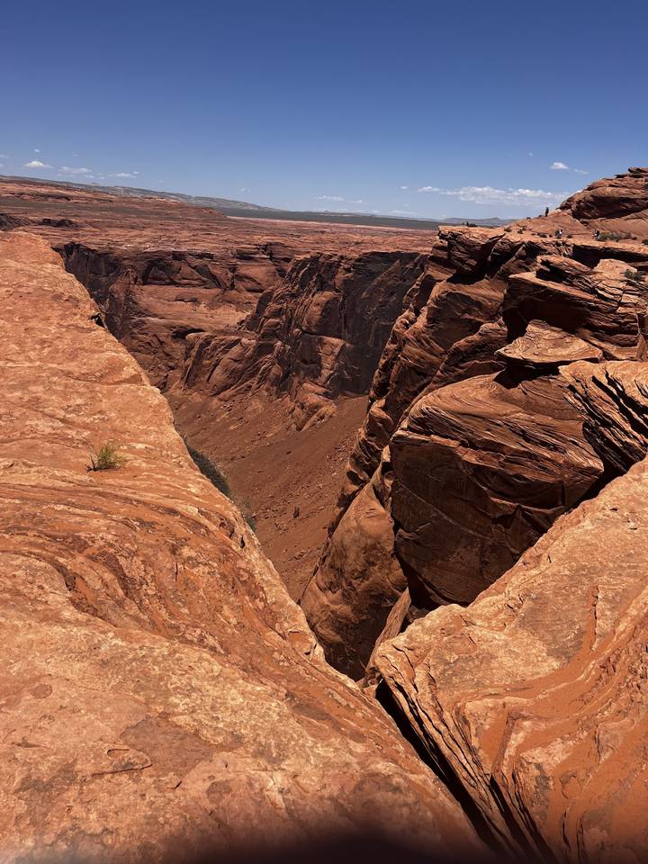 Canyon landscape with shadows and red rock formations.