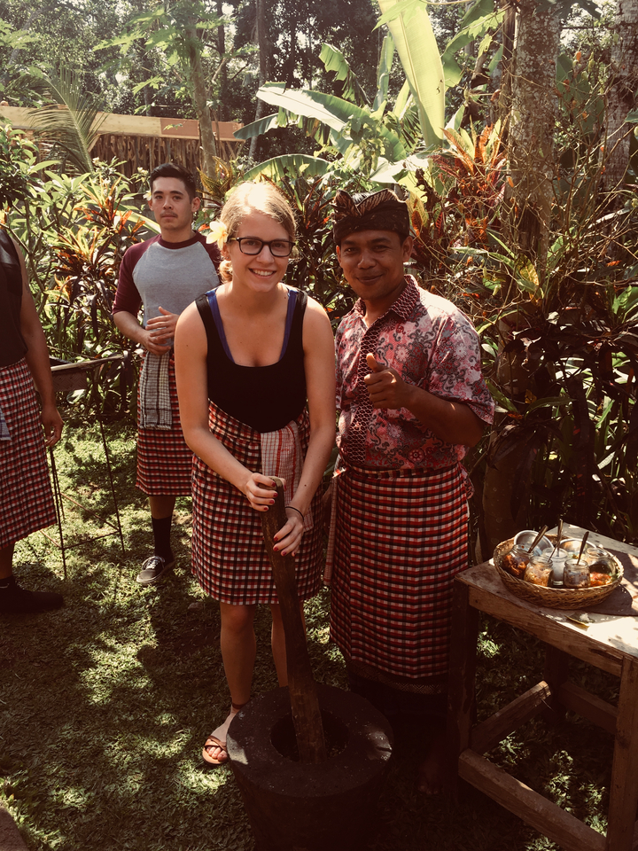 Group wearing traditional clothing, engaged in an outdoor activity.