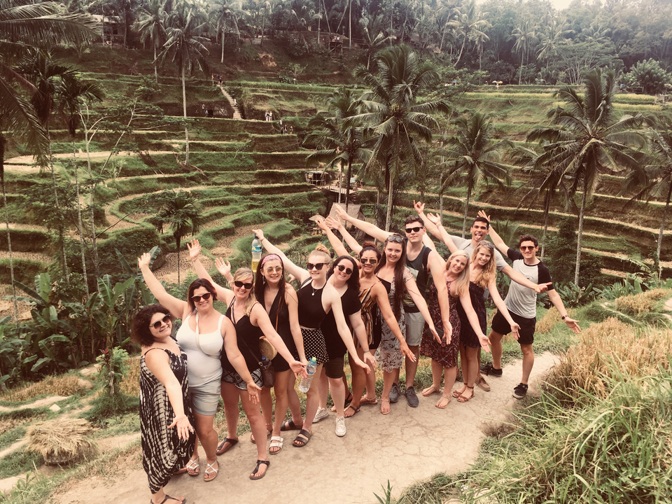Group posing at terraced rice fields.
