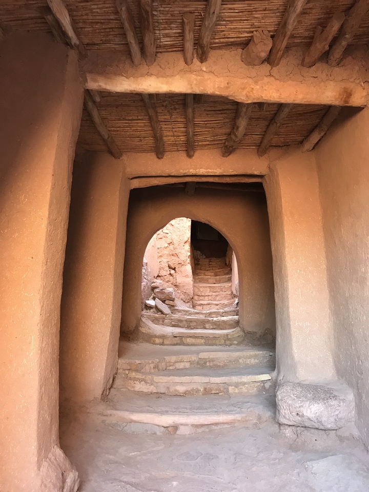 A pathway through adobe-style architecture.