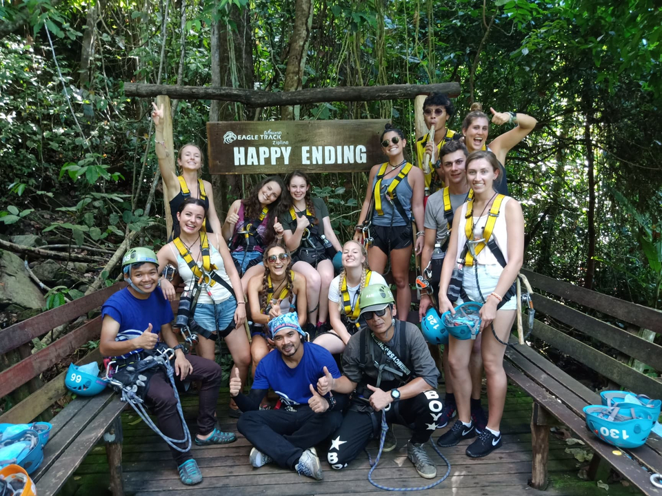 Group of people with safety gear posing for a photo after outdoor activity.