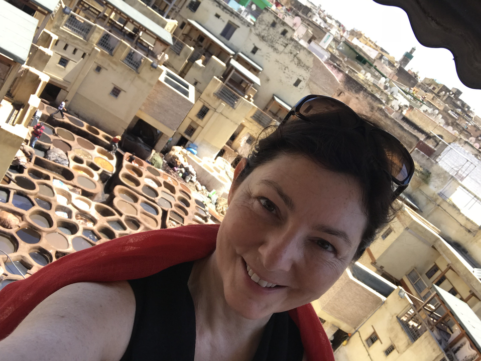 Woman taking a selfie with a view of traditional tanneries.