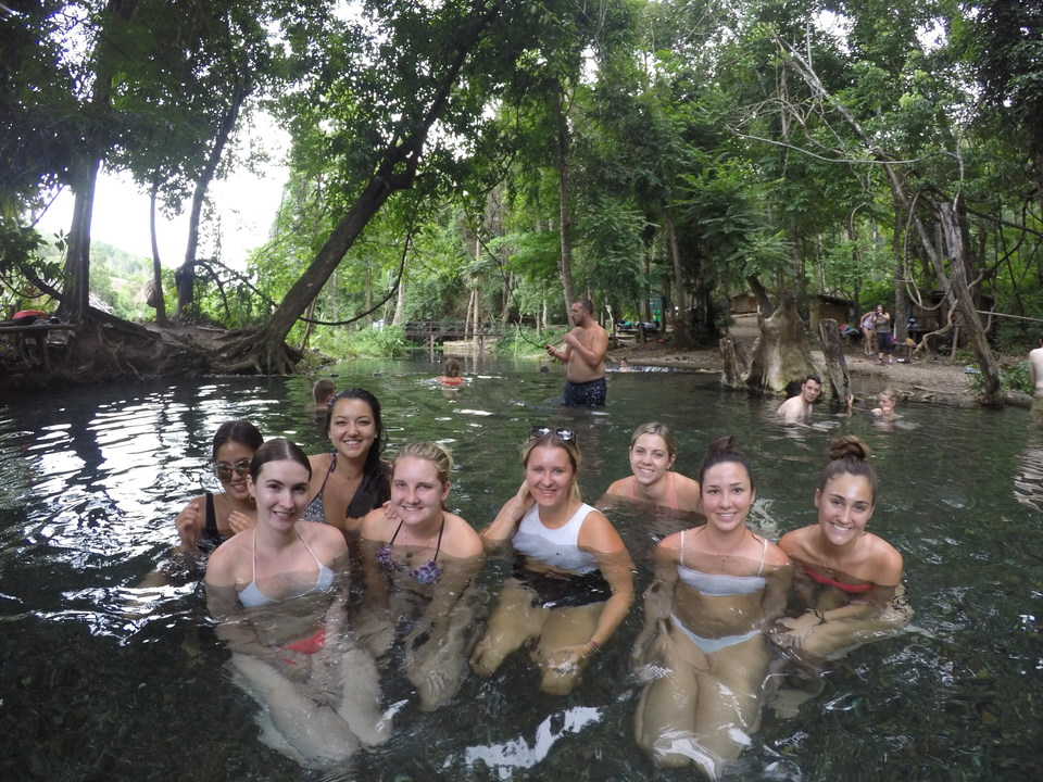 People enjoying a natural spring pool.
