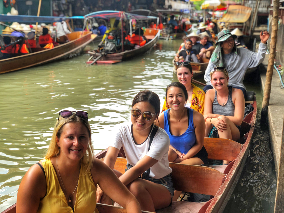 People in small boats at a floating market.