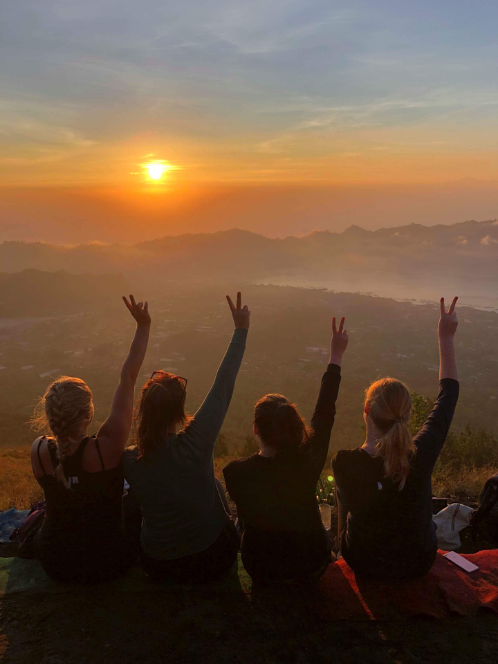 Group of people watching the sunset with a scenic view.