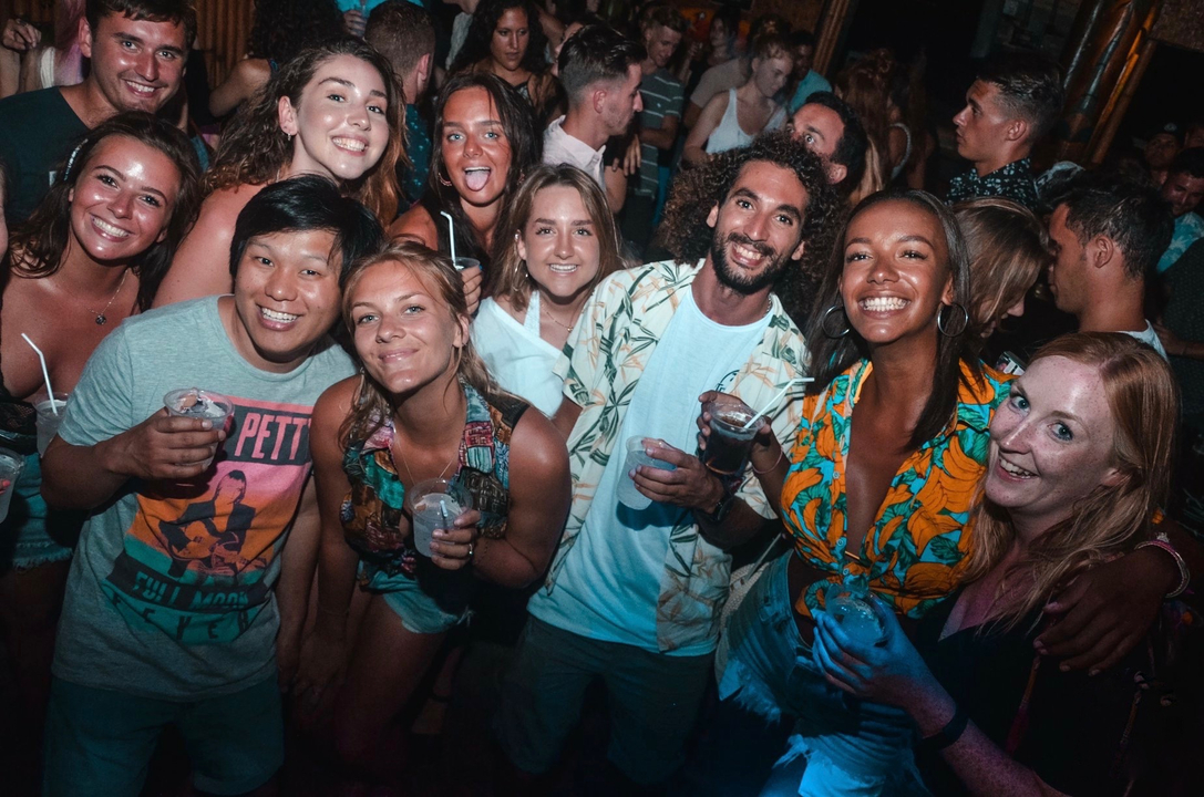 A group of friends at a lively party posing for a photo.
