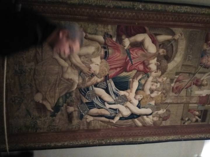 A tapestry on display in a museum.