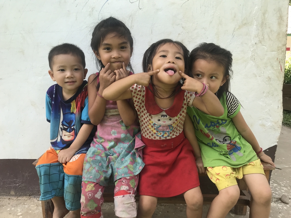 Four children smiling and making funny faces.