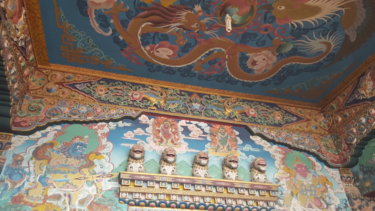 Intricate and colorful mural with dragons and mythical figures.