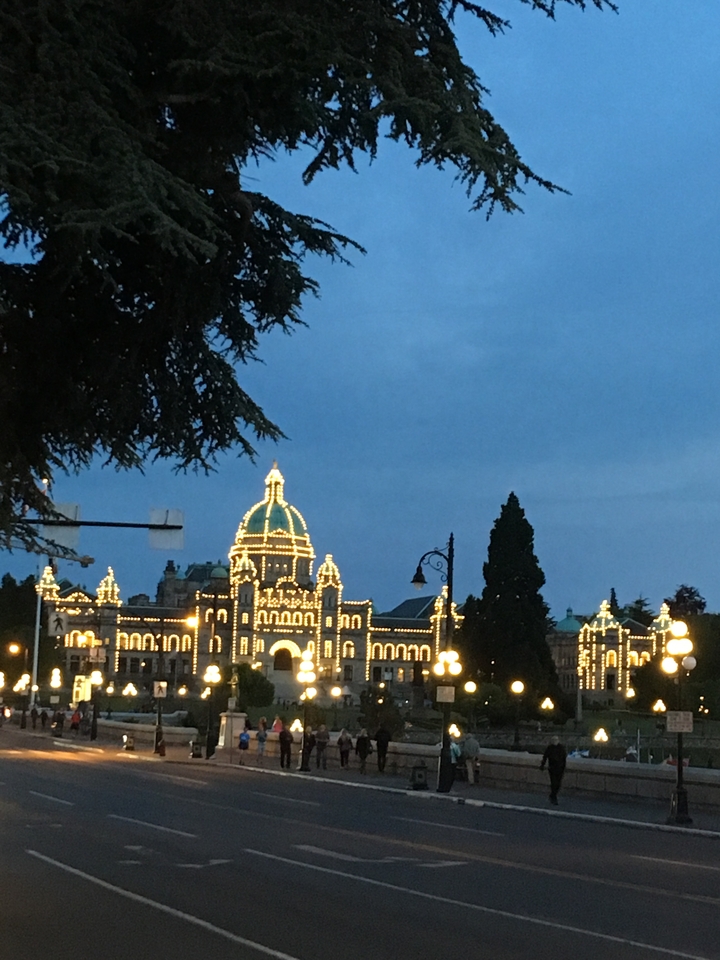Illuminated building at dusk in a cityscape