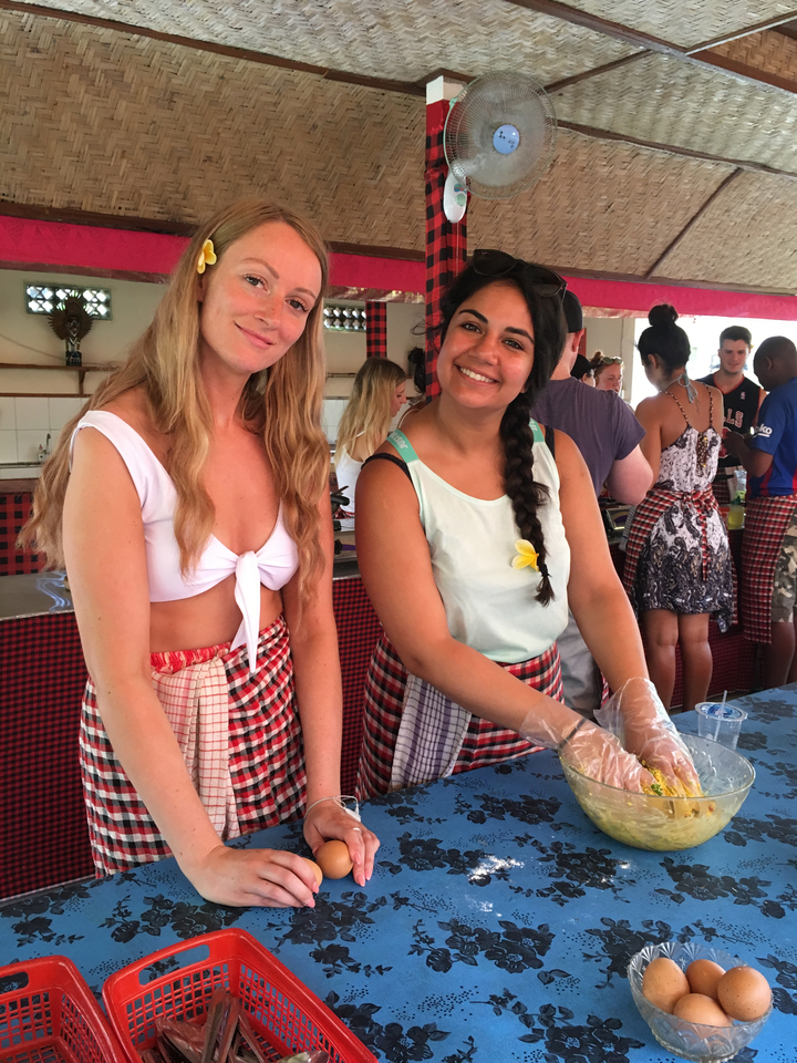 Two women preparing food at a cooking class.