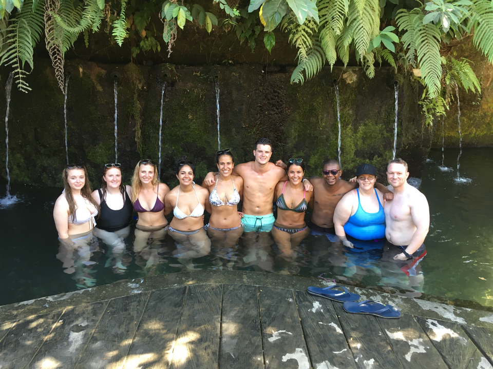 Group of people posing in a submerged pool area.