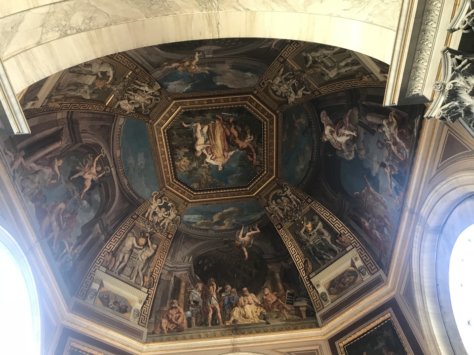 Intricately painted arched ceiling depicting mythological scenes.