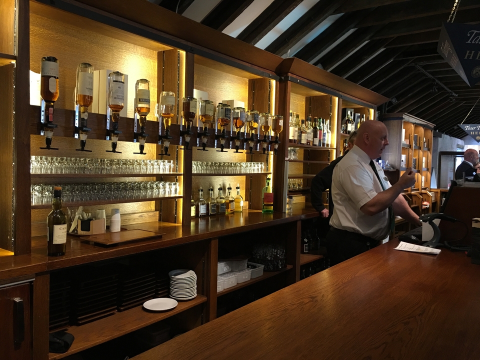 Bar interior with whiskey bottles lined up.