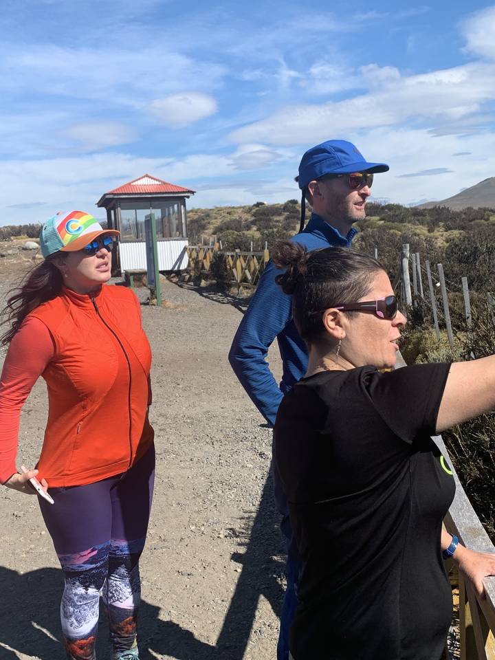 People standing outdoors with a mountain backdrop.