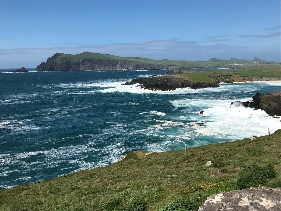 Scenic coastal landscape with cliffs and waves.
