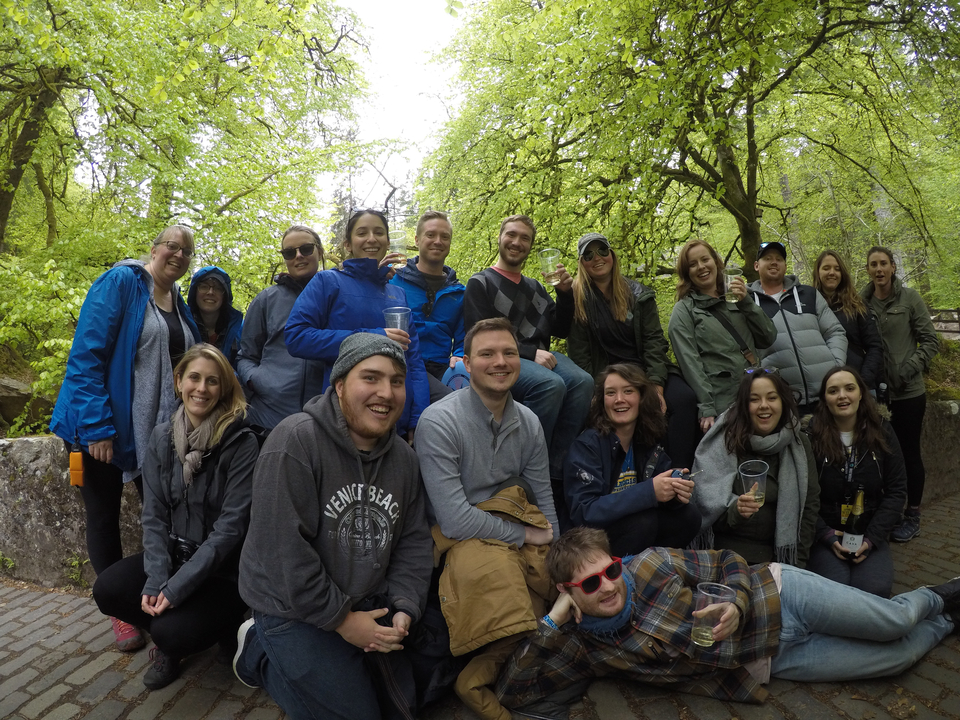 Large group posing in a wooded area.