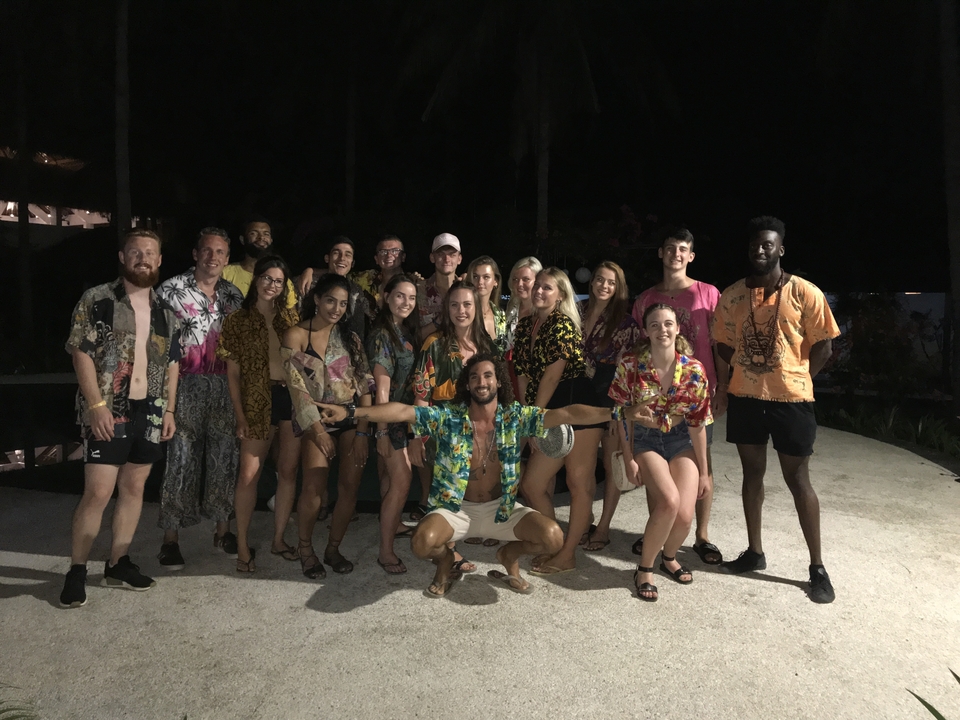 Group photo of people in casual attire at night.