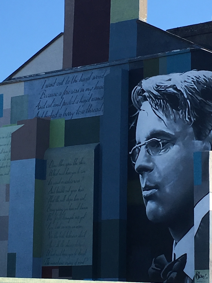 A mural featuring a portrait of a man with notes.