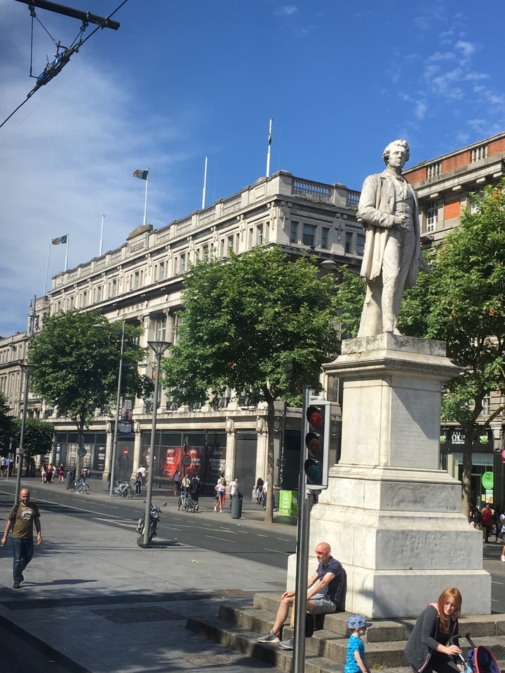 A statue in front of a historic building.