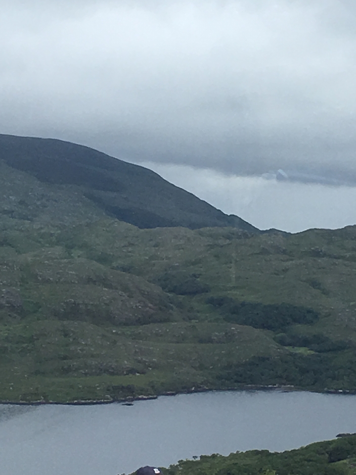 A rugged landscape scene of hills and valleys.