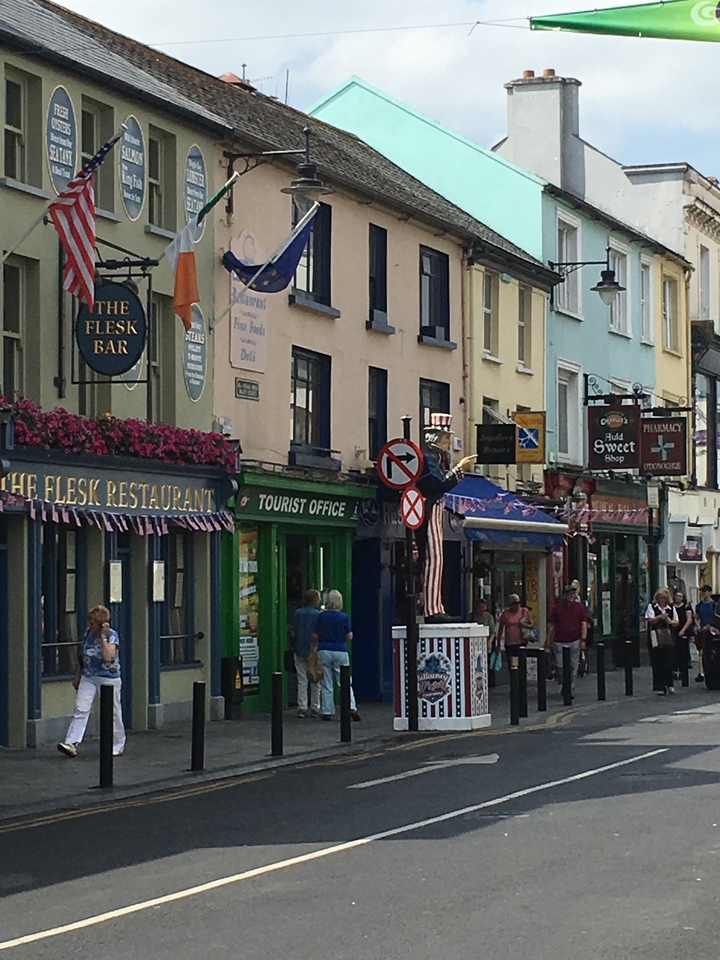A busy street with colorful shops and signs.