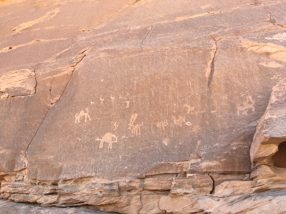 Rock carvings with ancient symbols and figures.