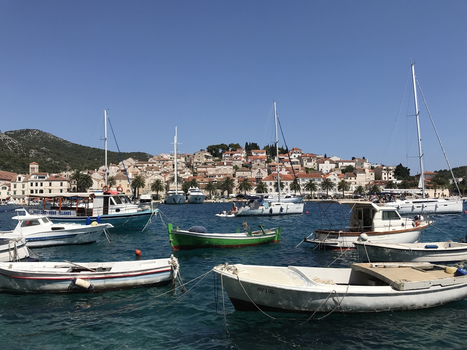 View of a coastal village with boats in a harbor.