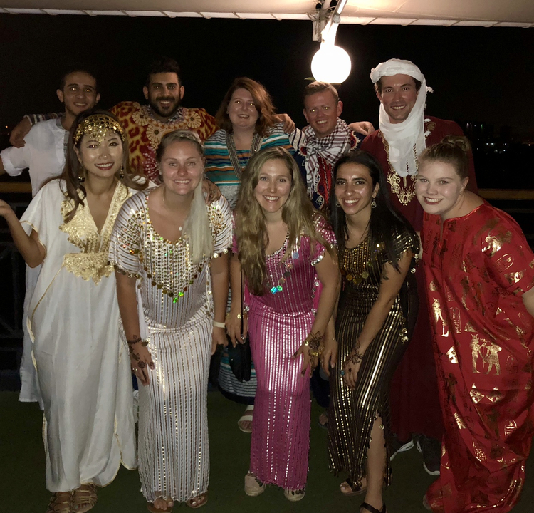 Group of people wearing traditional outfits.