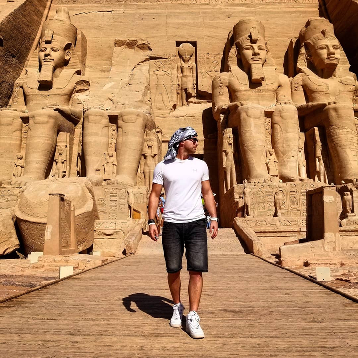 Person standing in front of an ancient temple.