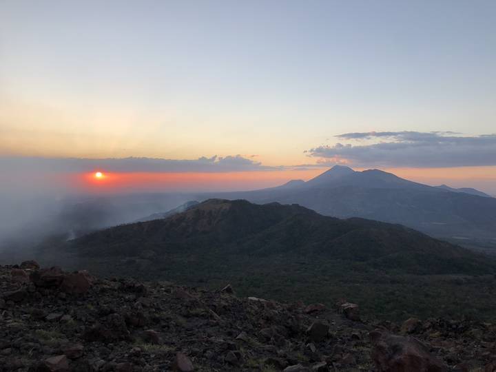 Distant mountains silhouetted against a sunset sky.