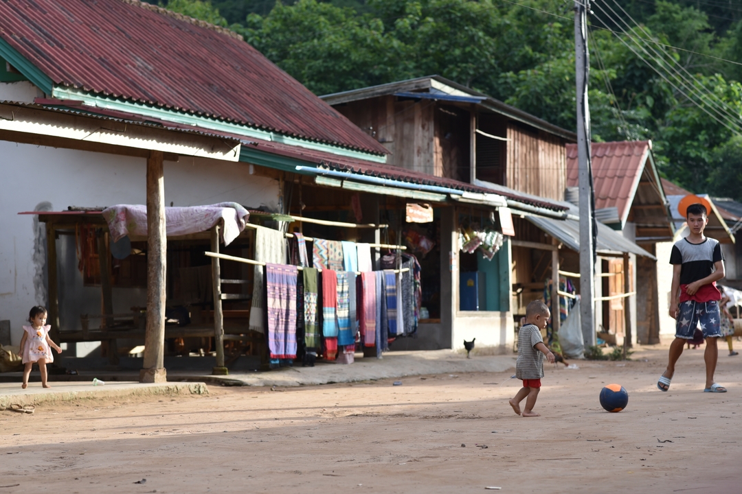 A rural village scene with children playing.