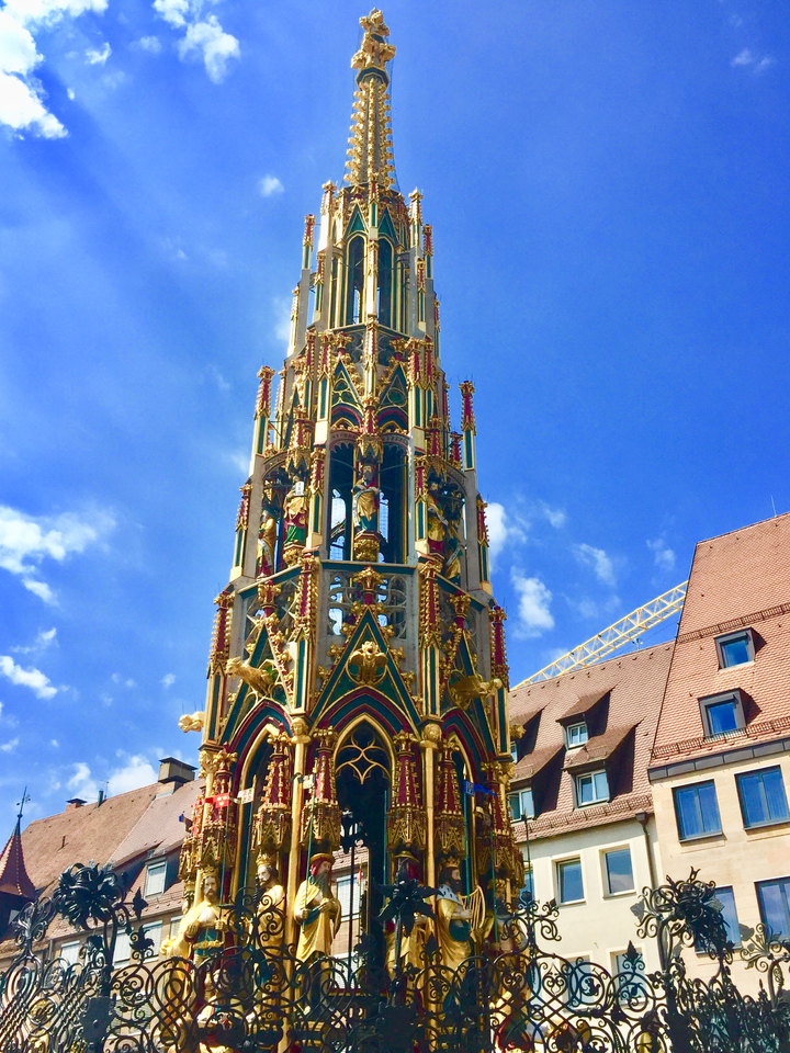 Ornate historical structure with colorful details against a blue sky.