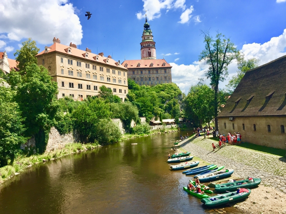 River with canoes and a castle in the background.