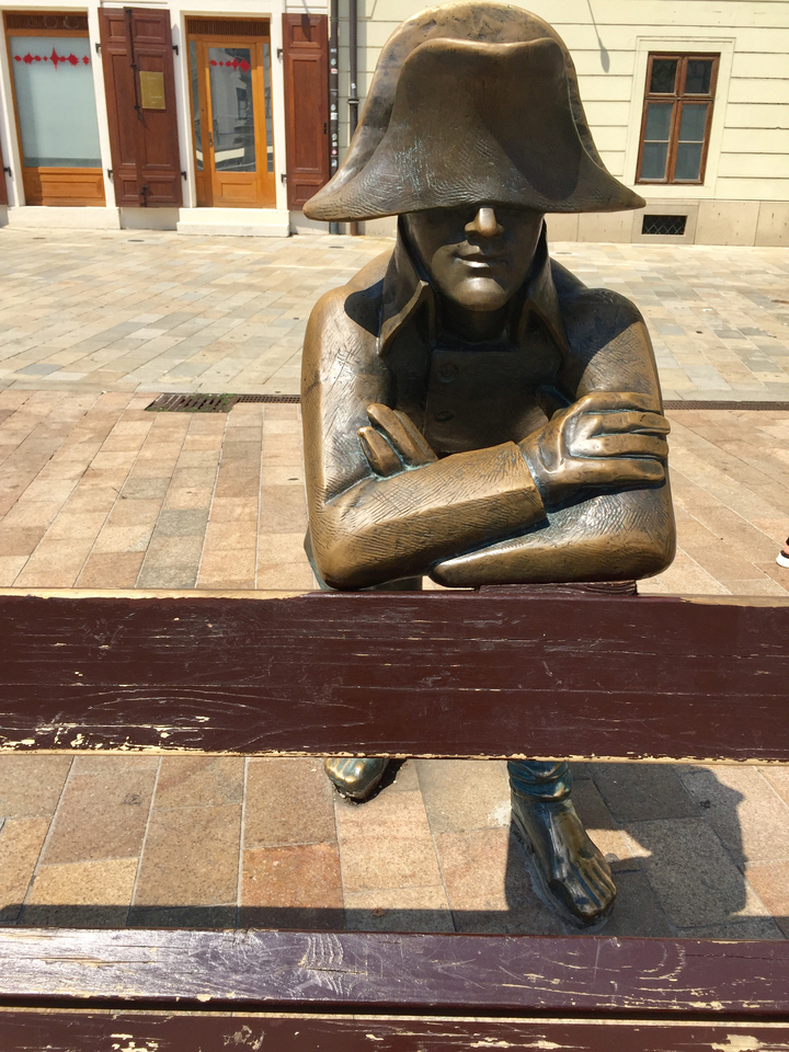 Statue of a person's arm and hand on a bench.