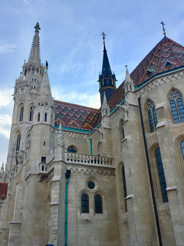 Ornate historical building with colorful roof design.