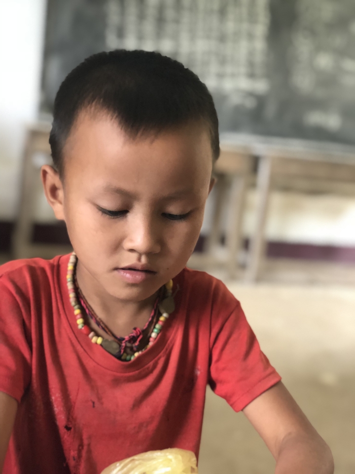 Close-up of a child in a classroom setting.